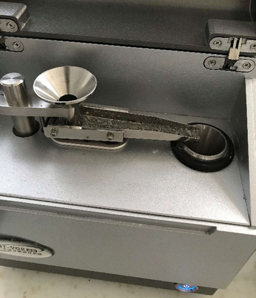 The dry feeder has cement added to the sample tray